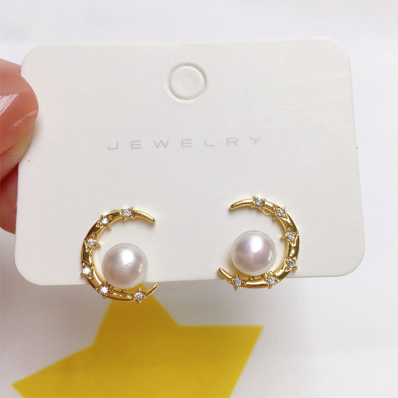 Freshwater pearl stud earrings, natural crescent shape, elegant gold-plated hardware.