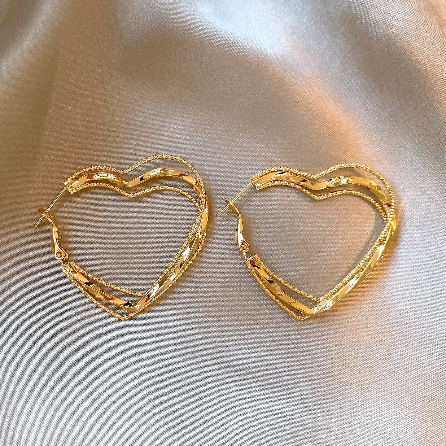 Second image of New multi-layered twisted heart-shaped large hoop earrings for women niche light luxury elegant versatile drop earrings.