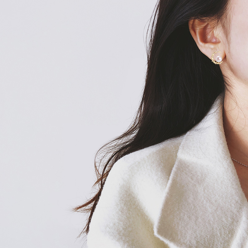 Second image of Freshwater pearl stud earrings, natural crescent shape, elegant gold-plated hardware.